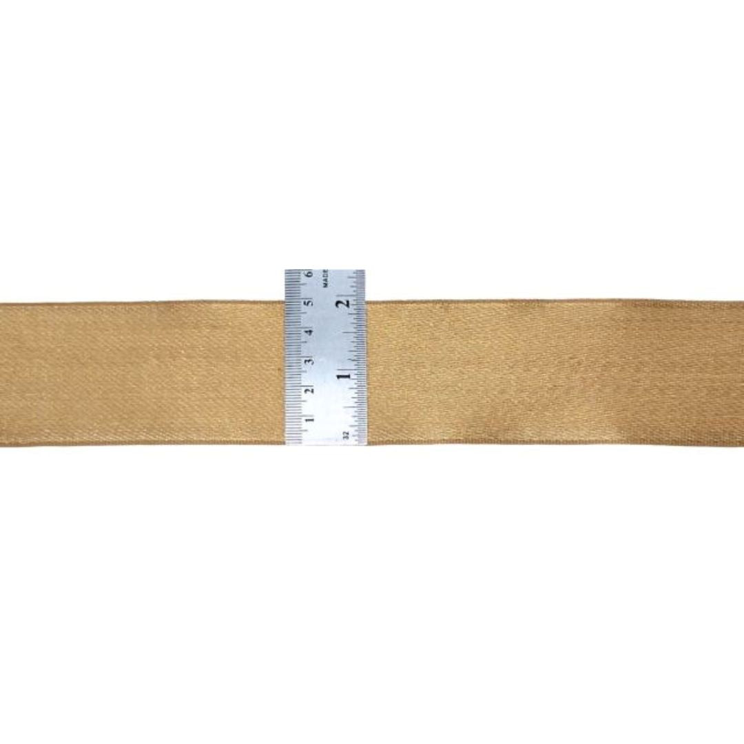 Beige fabric with a ruler for scale on a white background