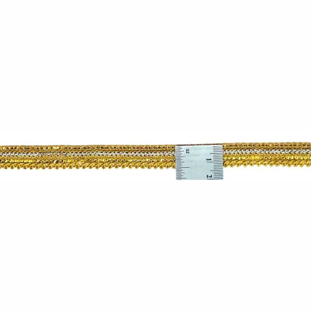 Gold chain with a ruler for scale on a white background