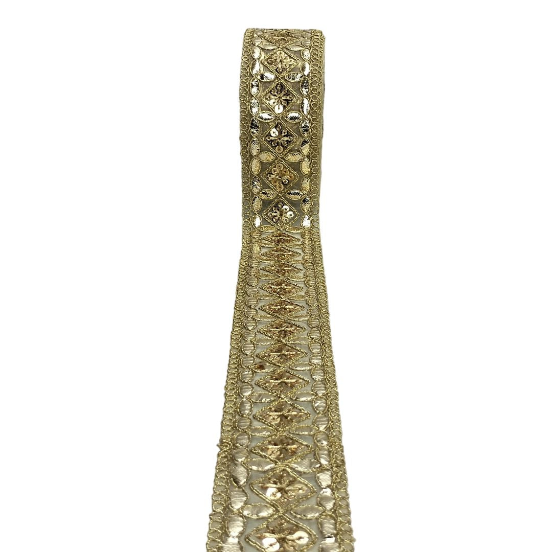Gold decorative ribbon with intricate patterns on a white background