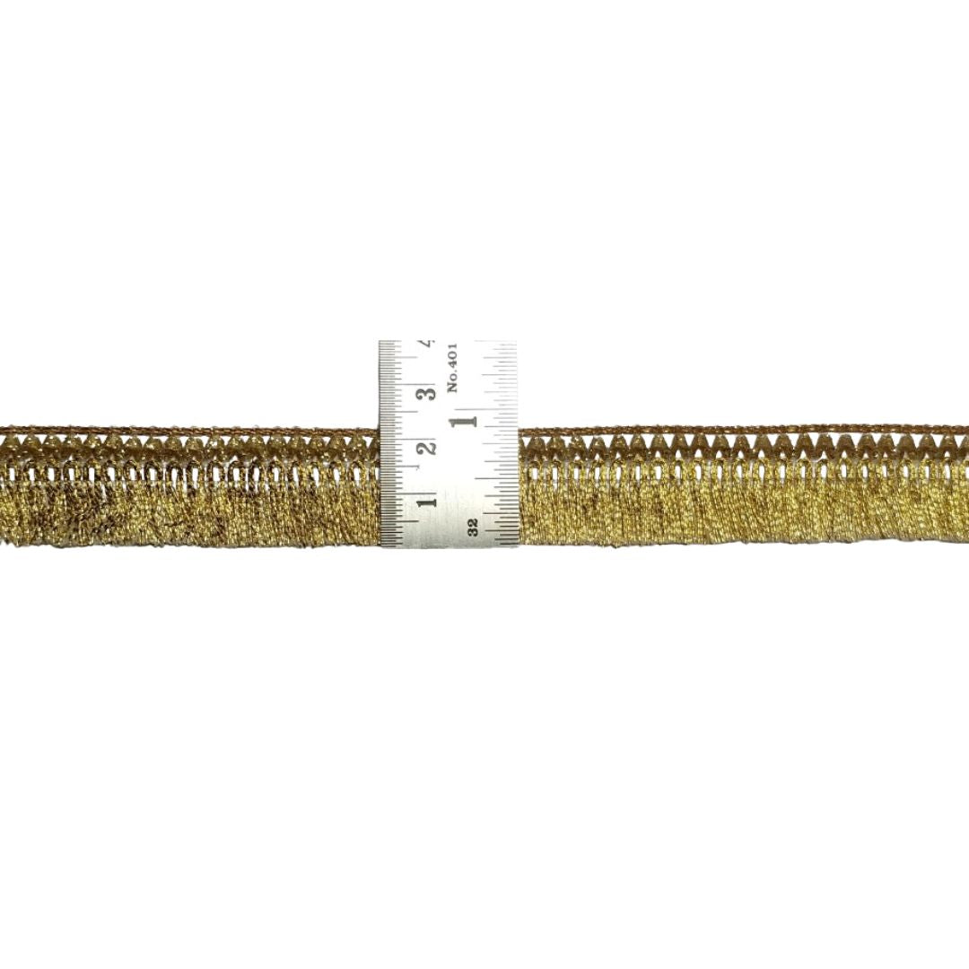 Gold zipper with a ruler for scale on a white background