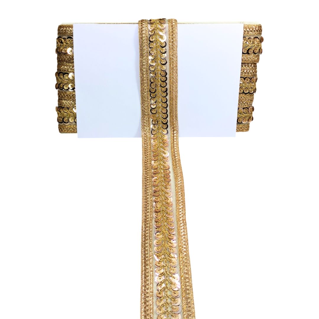 Decorative gold trim with sequins on a white background