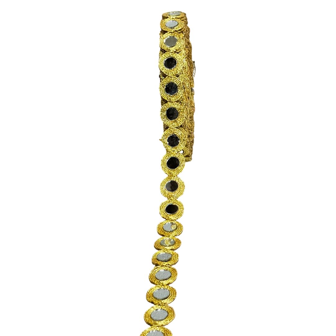 Gold bracelet with black and silver stones on a white background