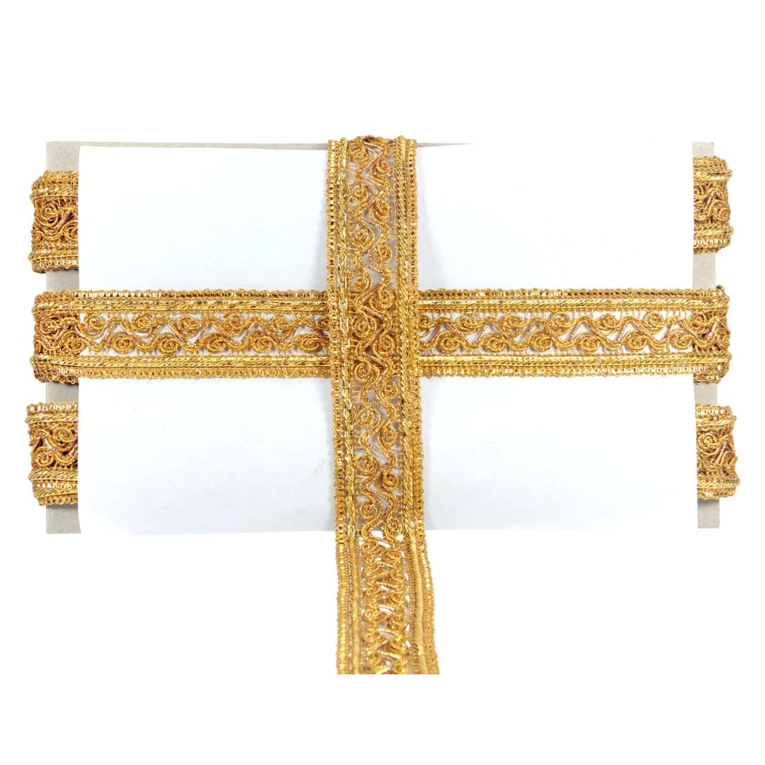 Decorative gold cross on a white background