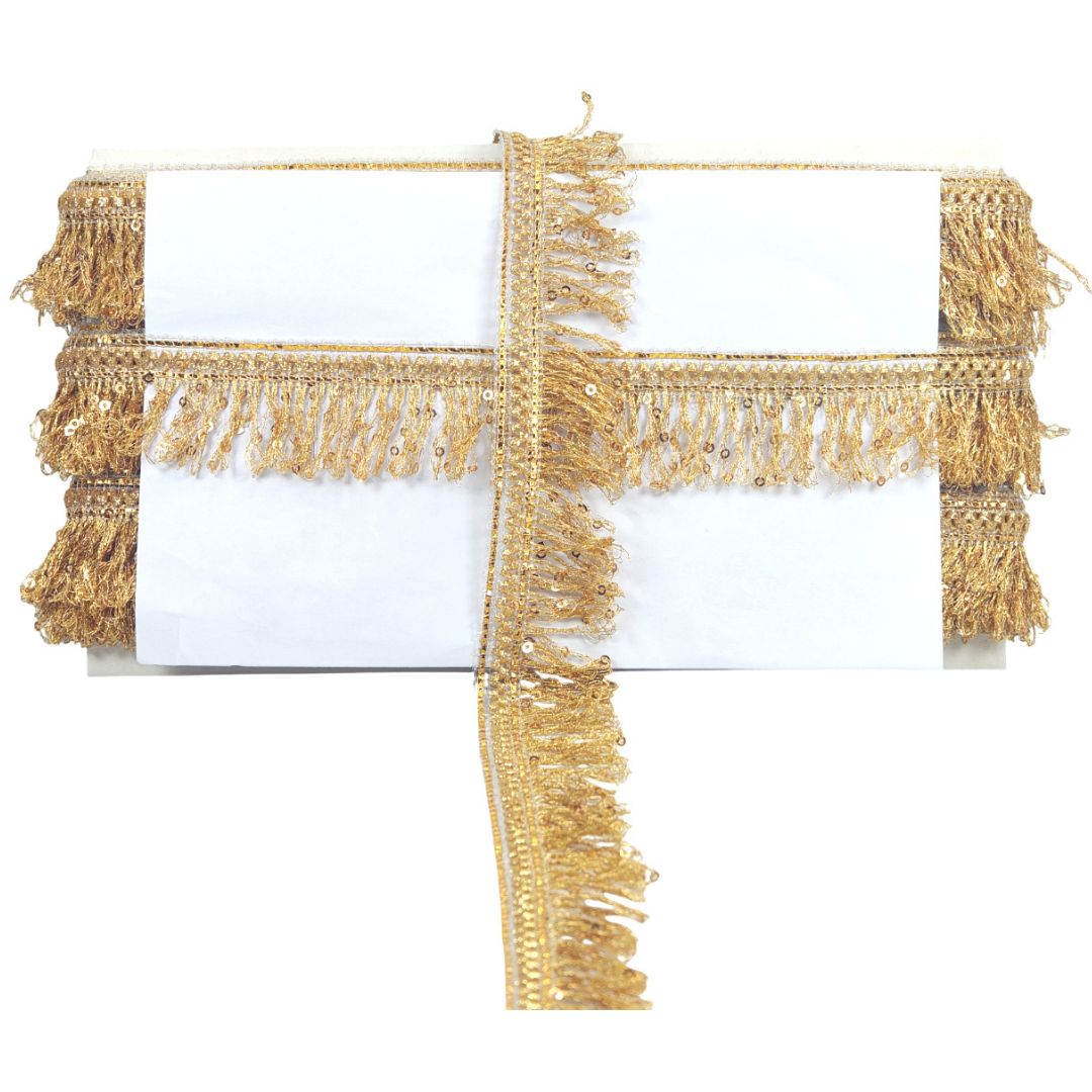 Gold fringe trim on a white background