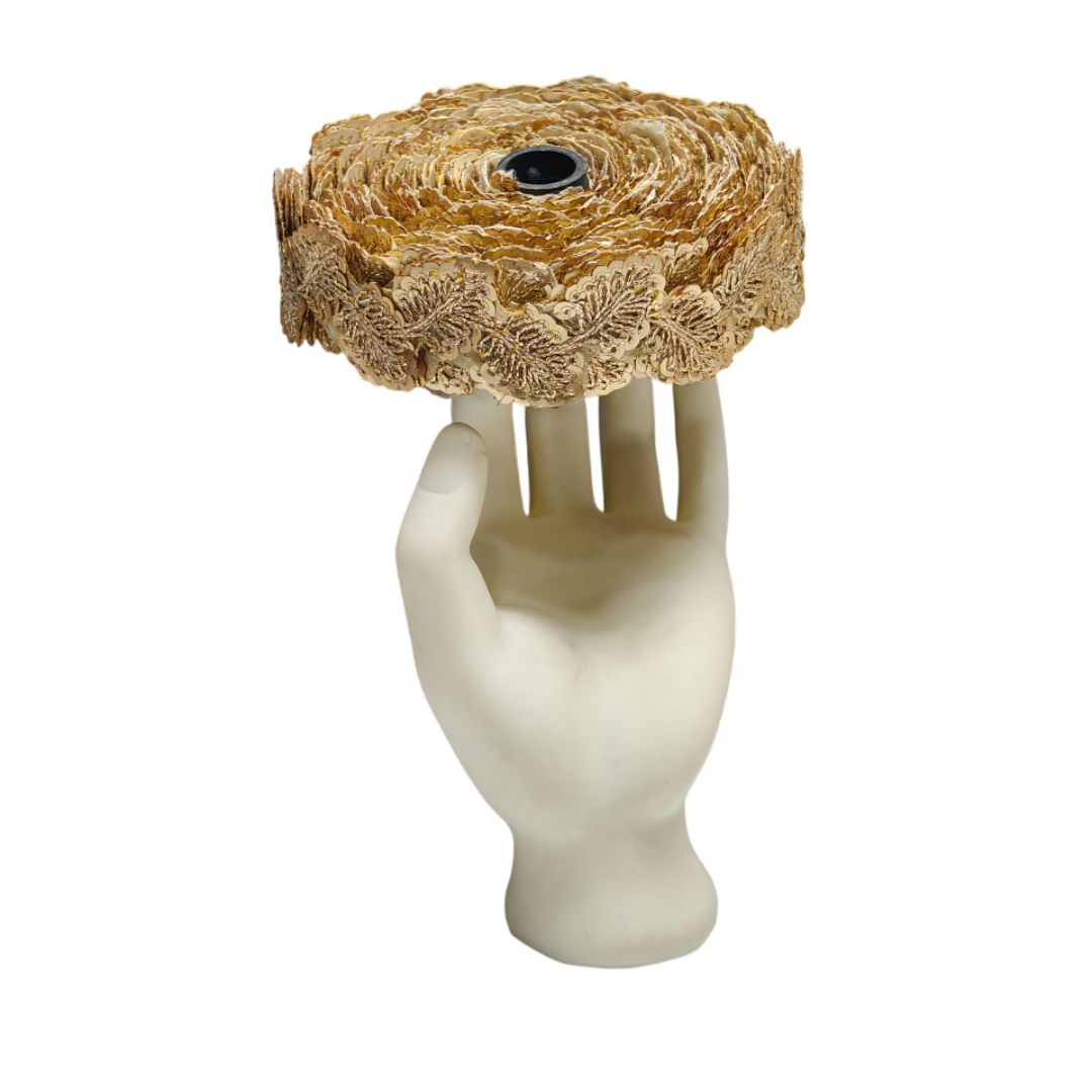 Mannequin hand holding a woven basket on a white background