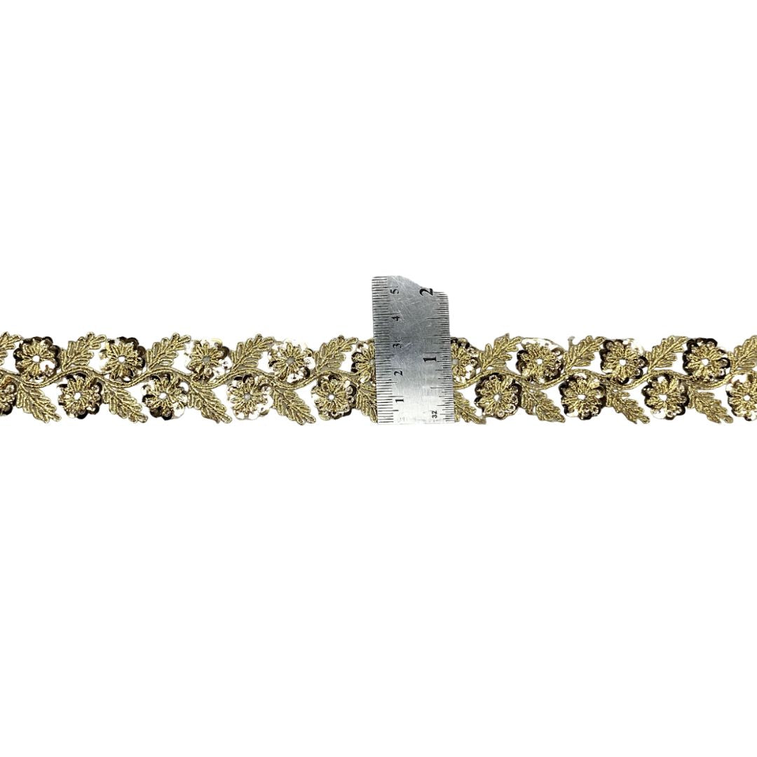 Decorative gold lace trim on a white background