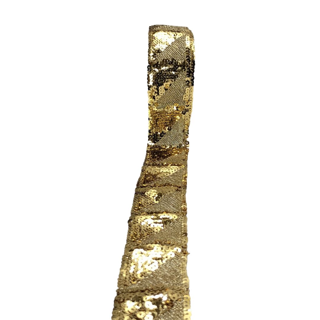 Gold sequin ribbon on a white background