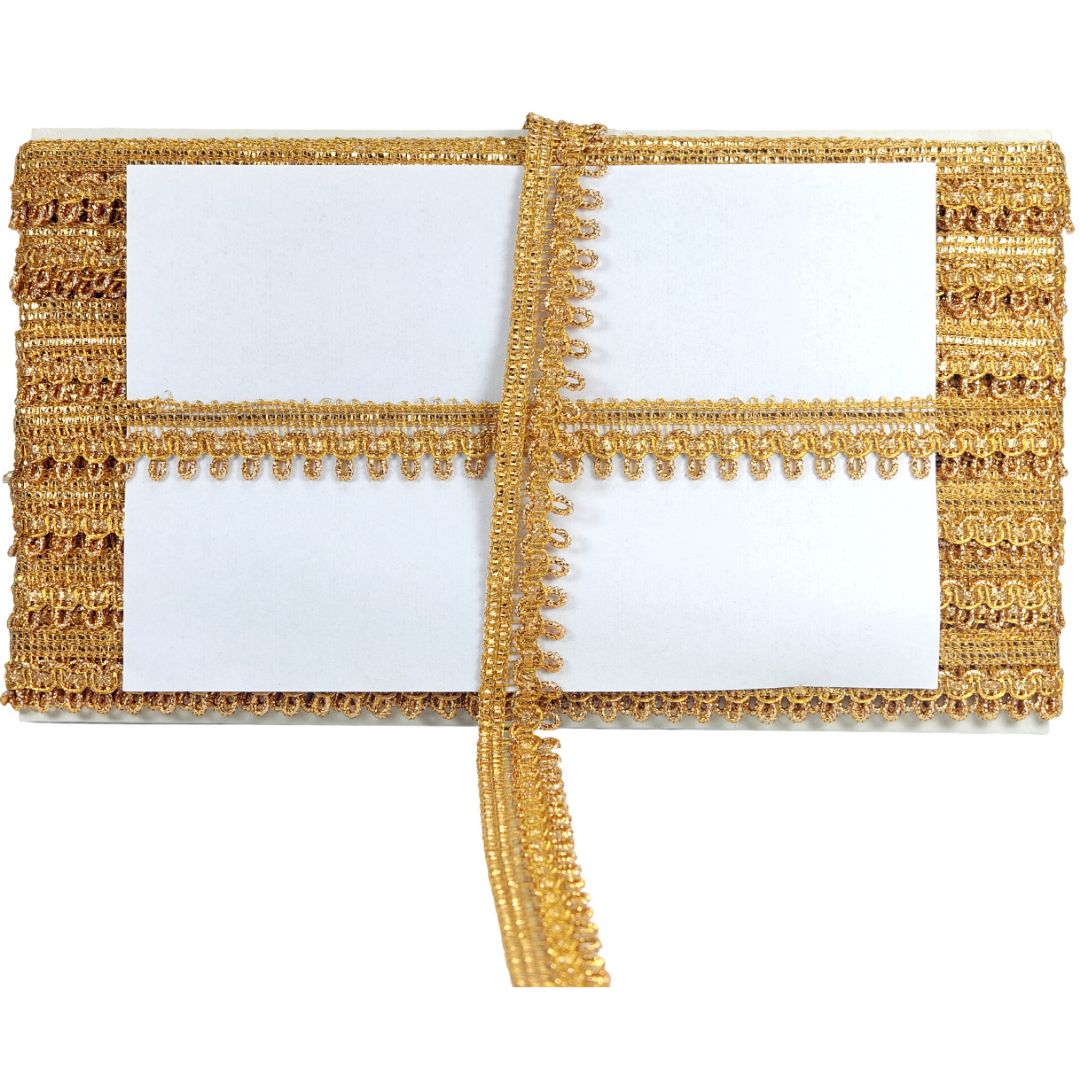 Two gold lace placemats with white centers on a white background
