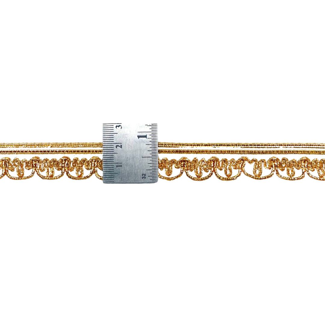 Gold chain with a ruler for scale on a white background