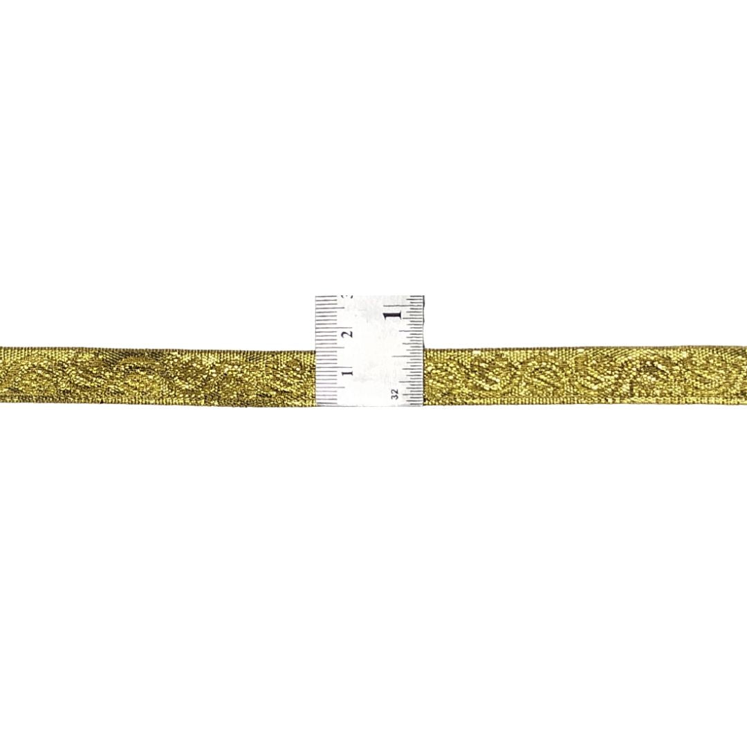 Gold metallic ribbon with a ruler for measurement on a white background