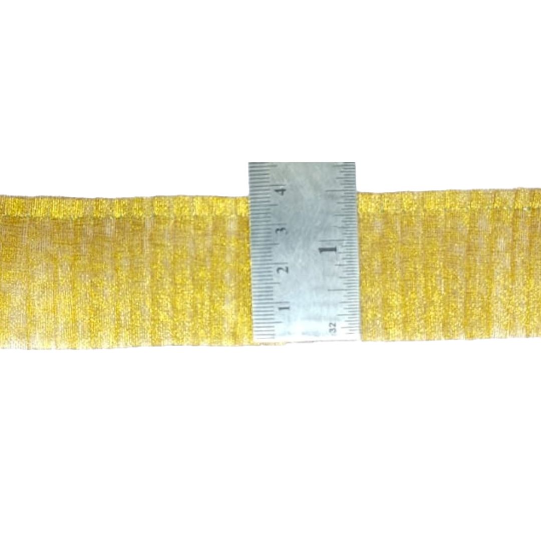 Gold ribbon with a ruler for measurement on a white background