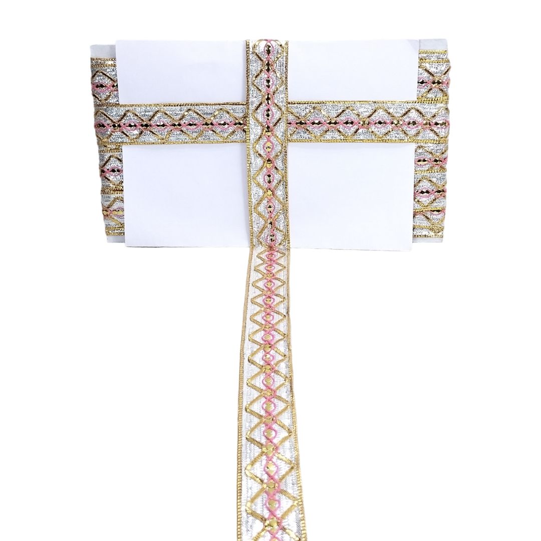 Decorative cross with pink and gold accents on a white background