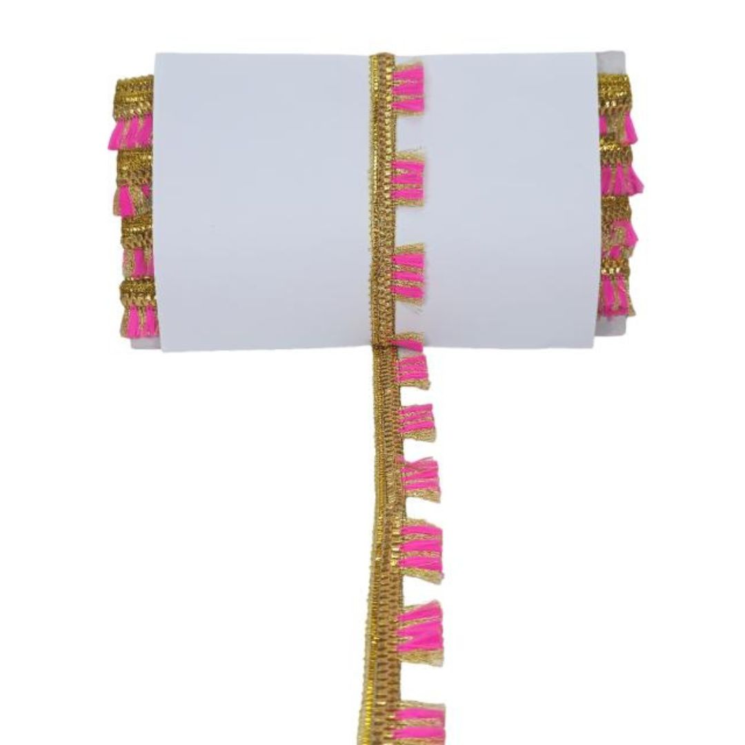 Decorative white napkin with pink and gold tassels on a white background