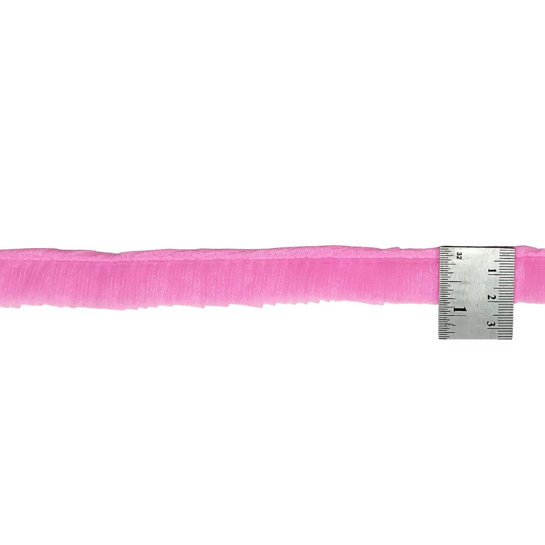 Pink ribbon with a ruler on a white background