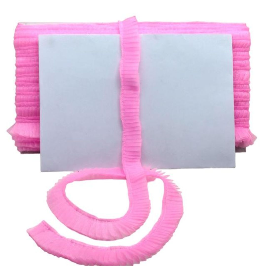 Pink ribbed bath mat with a long strip on a white background