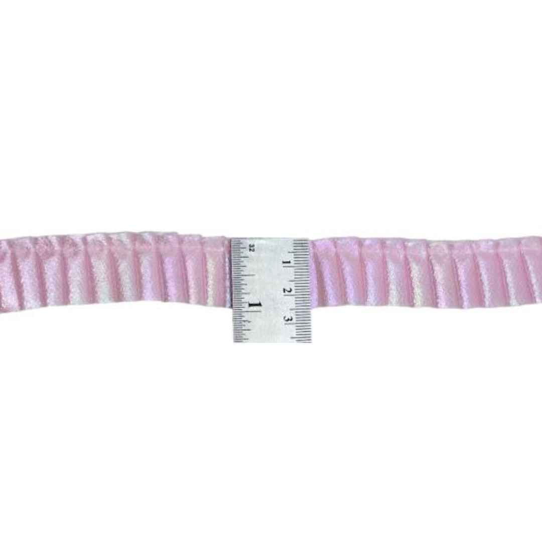 Pink ribbed belt with a ruler for size reference on a white background