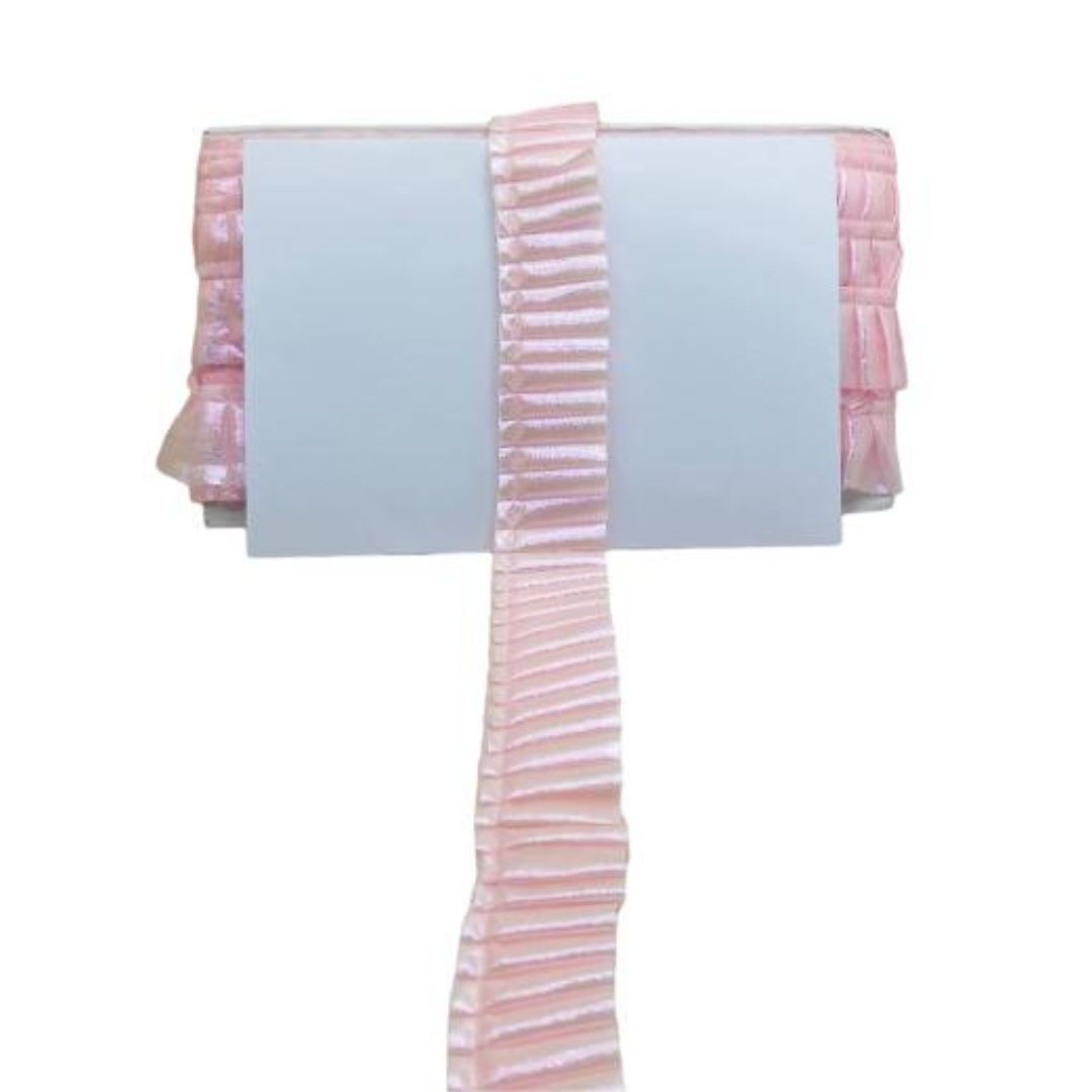 Pink and white striped fabric with ruffled edge on a white background