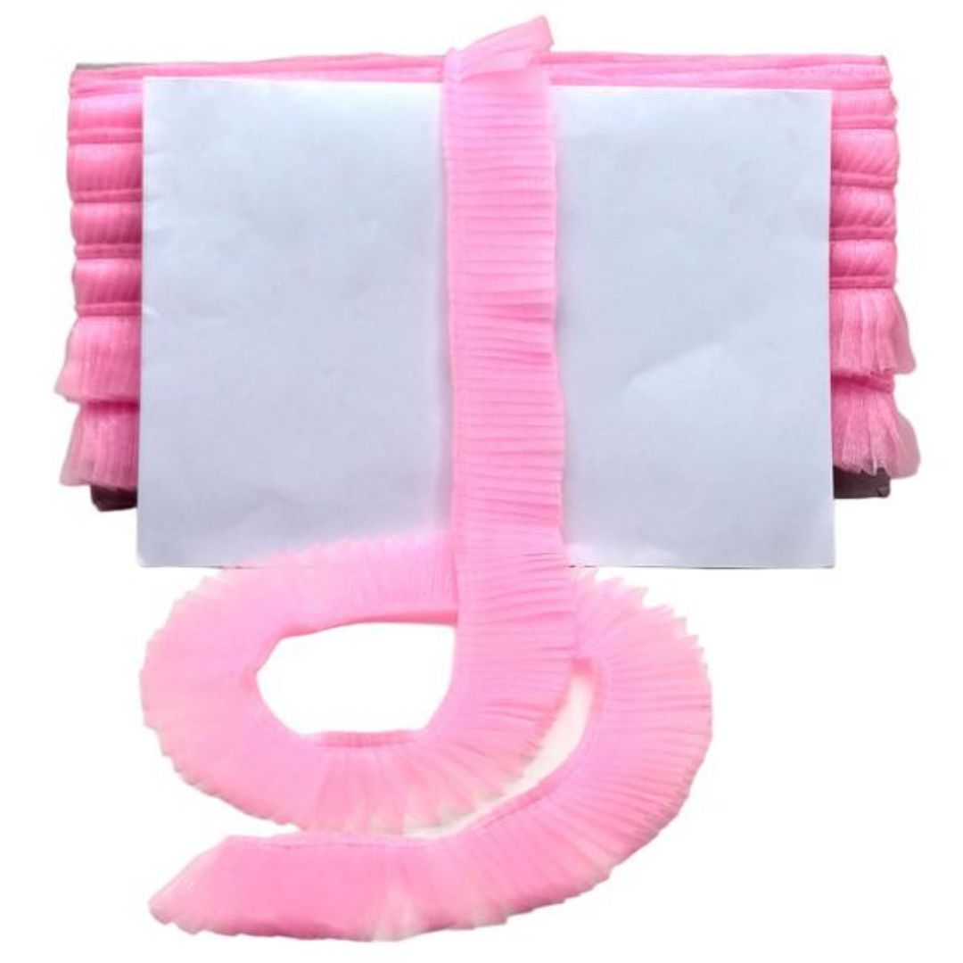Pink ribbed blanket with a white center on a white background