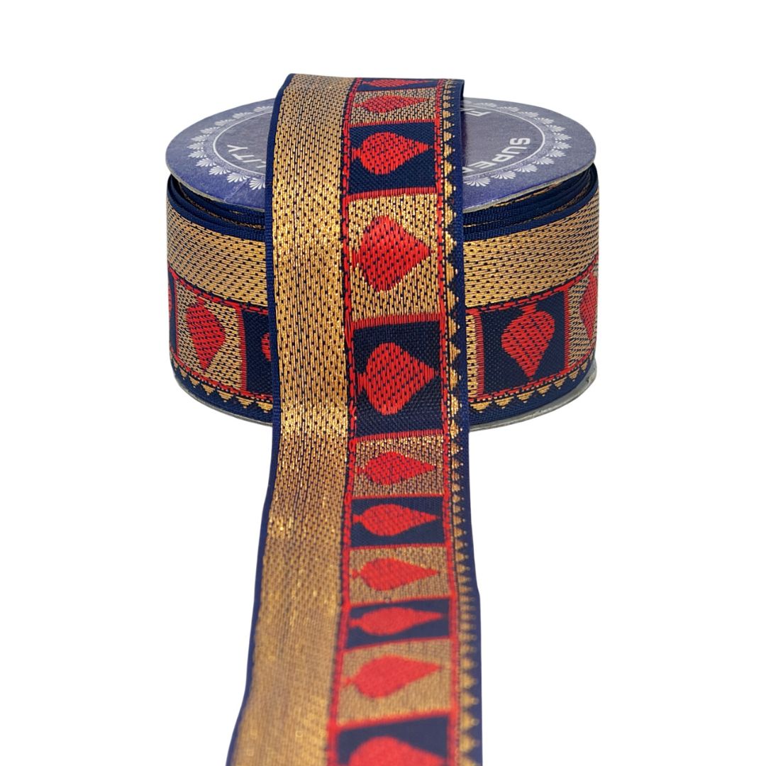 Decorative ribbon with red and gold pattern on a blue spool against a white background