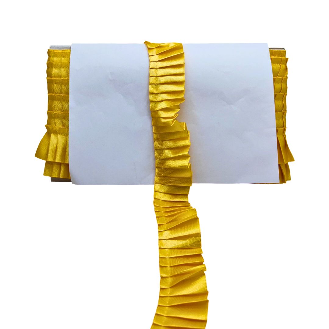 Yellow ruffled table runner on a white background