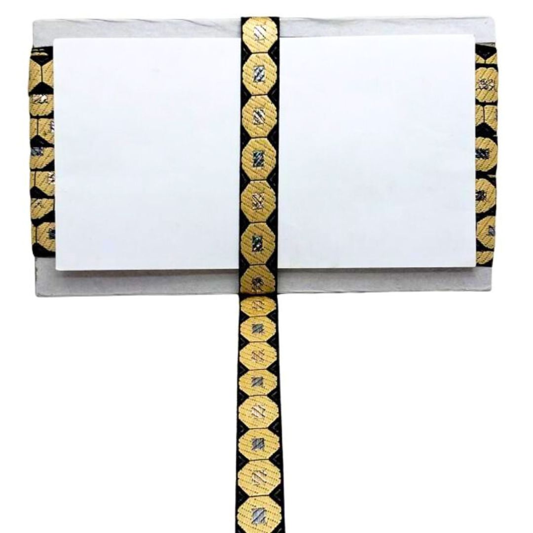 Decorative ribbon with gold and black pattern on a white background