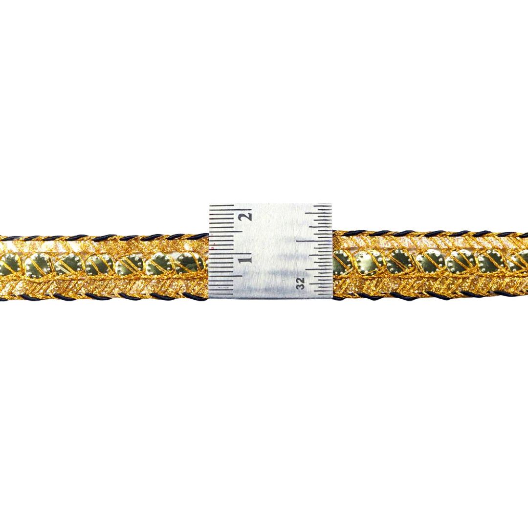 Gold braided cord with a ruler for scale on a white background