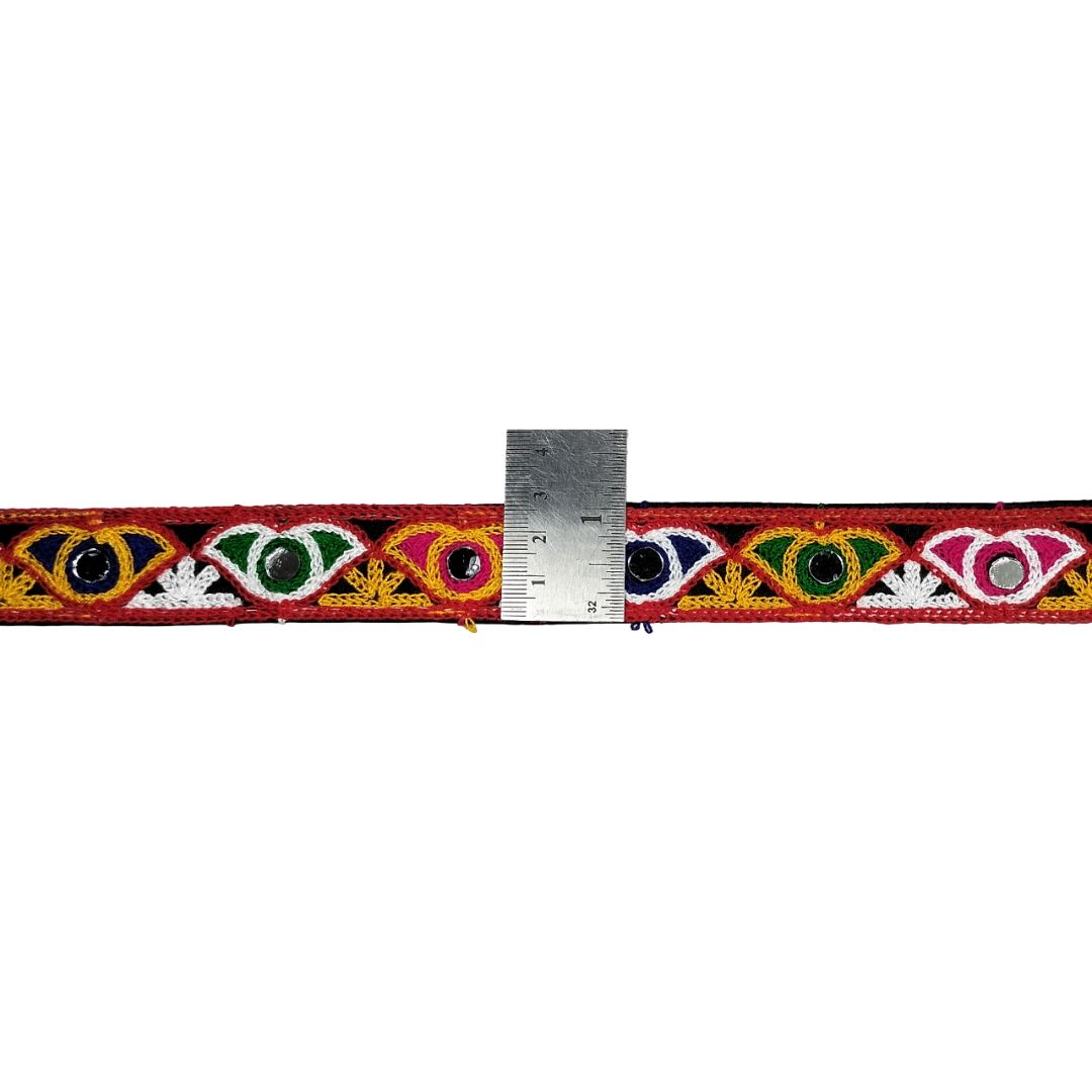 Colorful embroidered belt with a ruler for scale on a white background