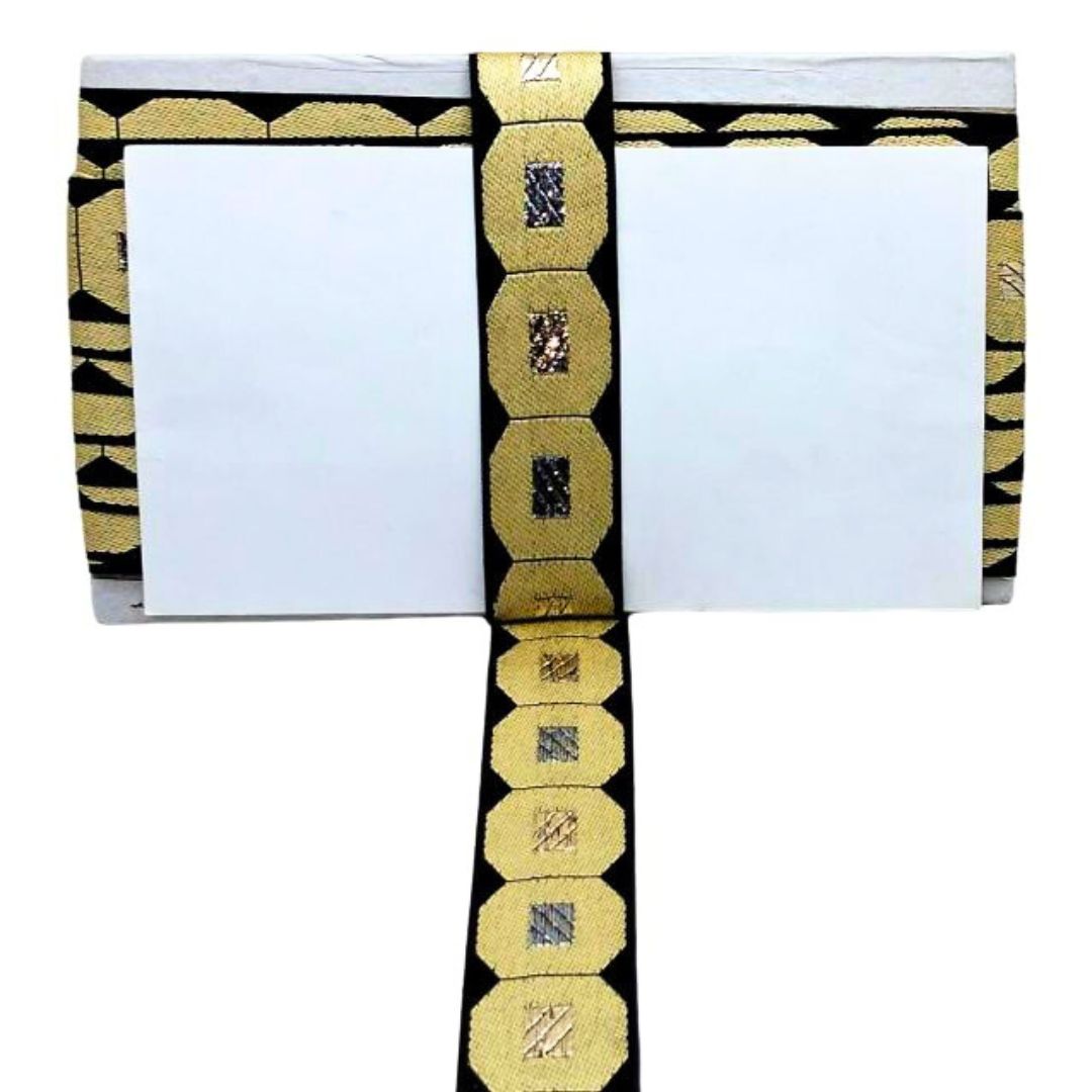 Decorative belt with gold and black pattern on a white background