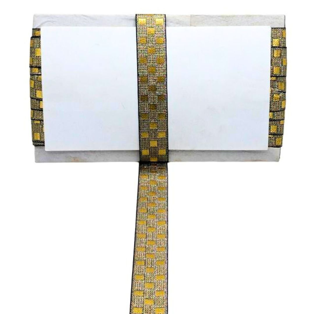 White card with gold and black patterned border on a white background