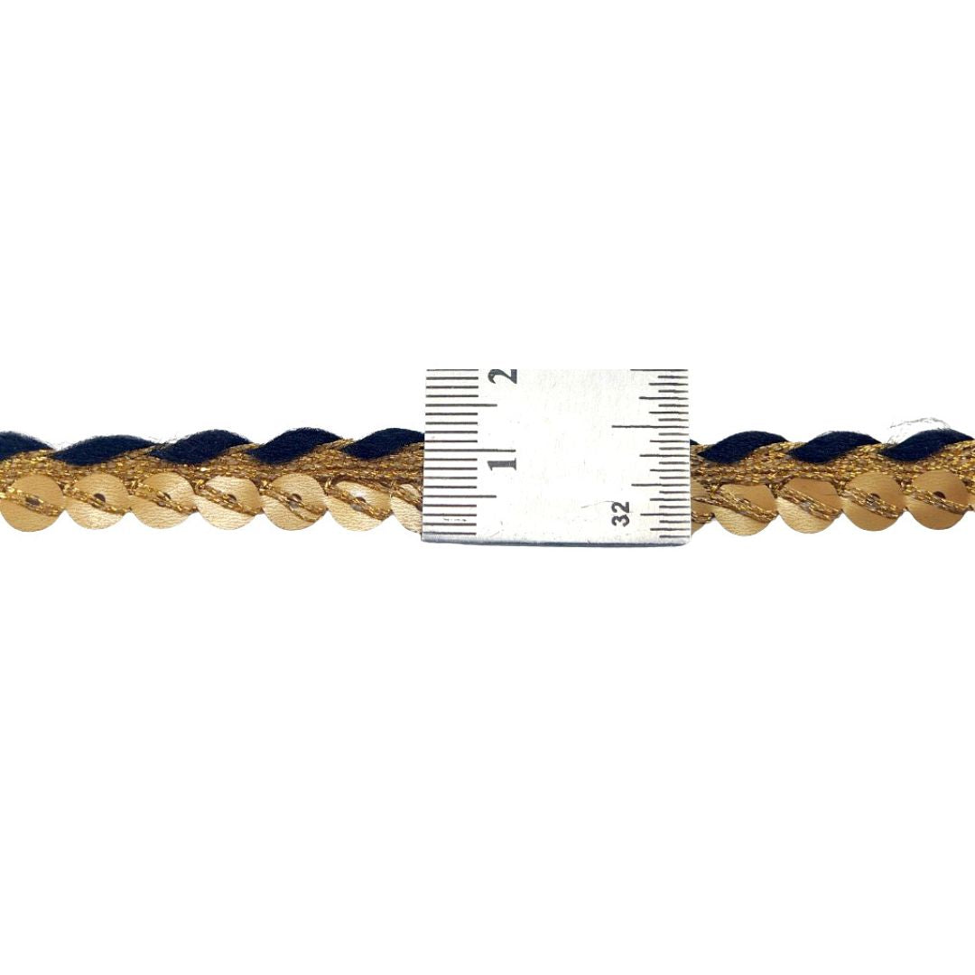 Gold chain with a ruler for scale on a white background