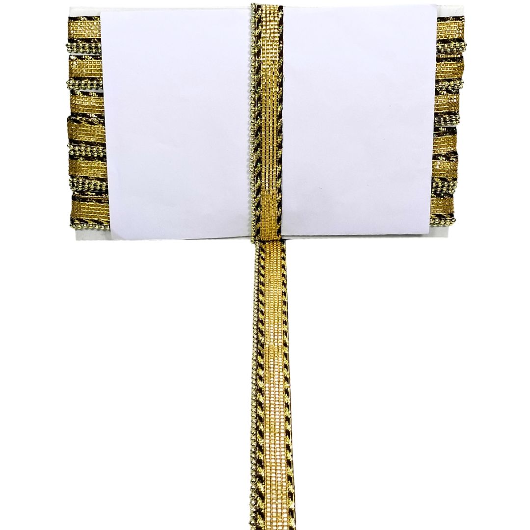 White pillow with gold and black decorative trim on a white background