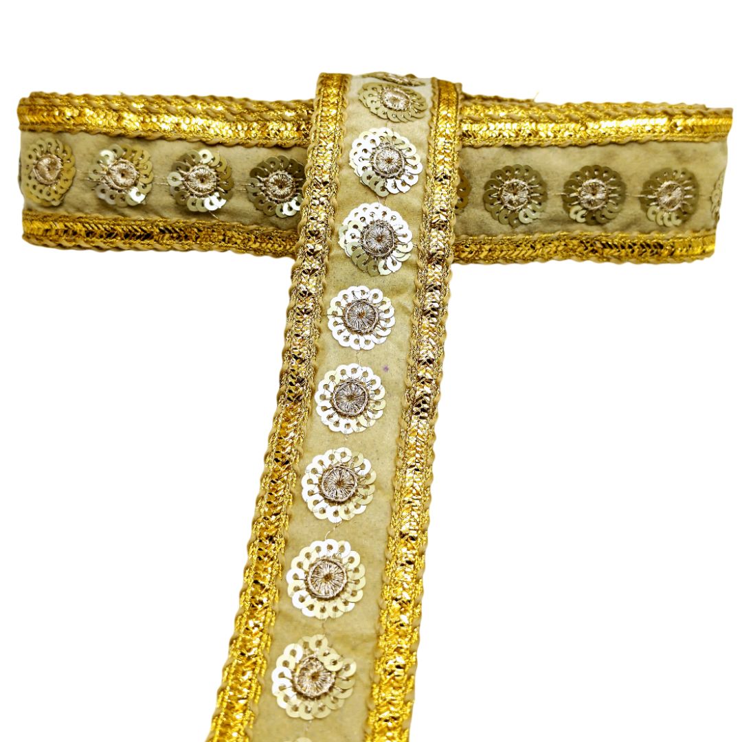 Decorative fabric trim with gold and beige colors on a white background