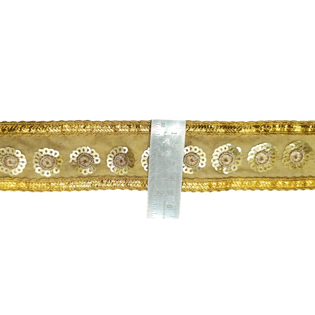 Gold decorative ribbon with white floral patterns on a white background