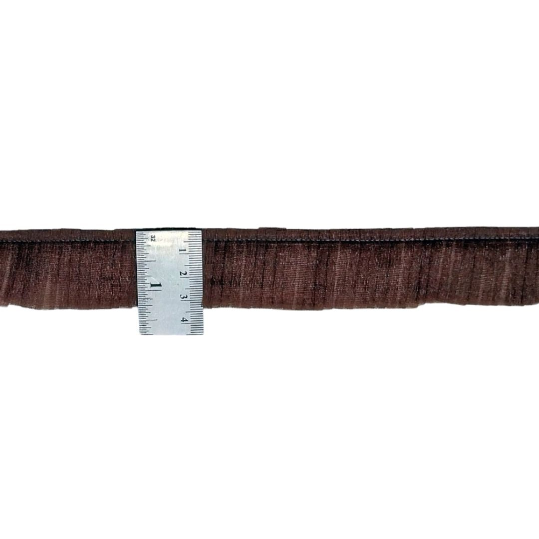 Brown belt with a ruler for size reference on a white background