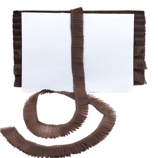 Brown fringed fabric on a white background