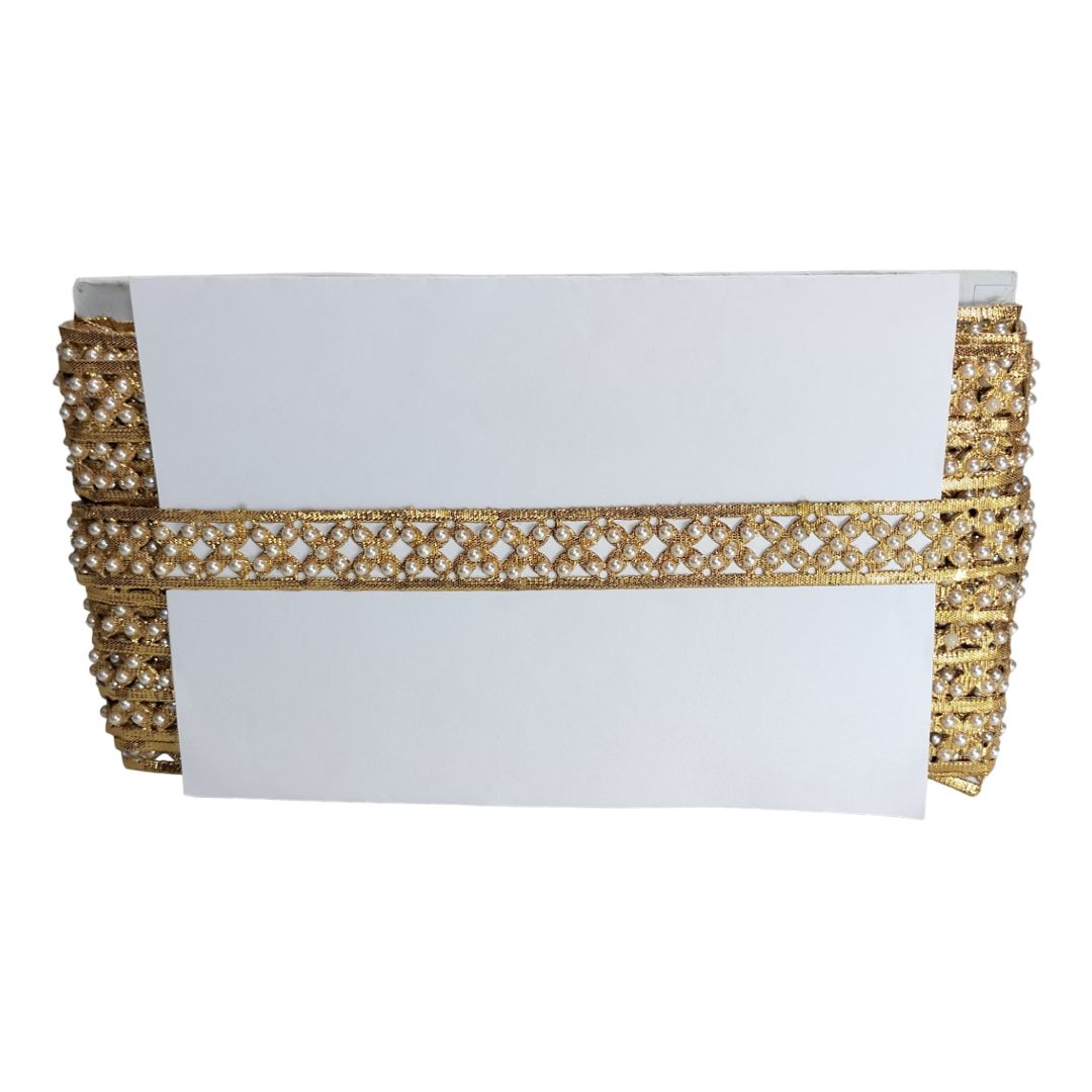 White clutch with gold beaded border on a white background