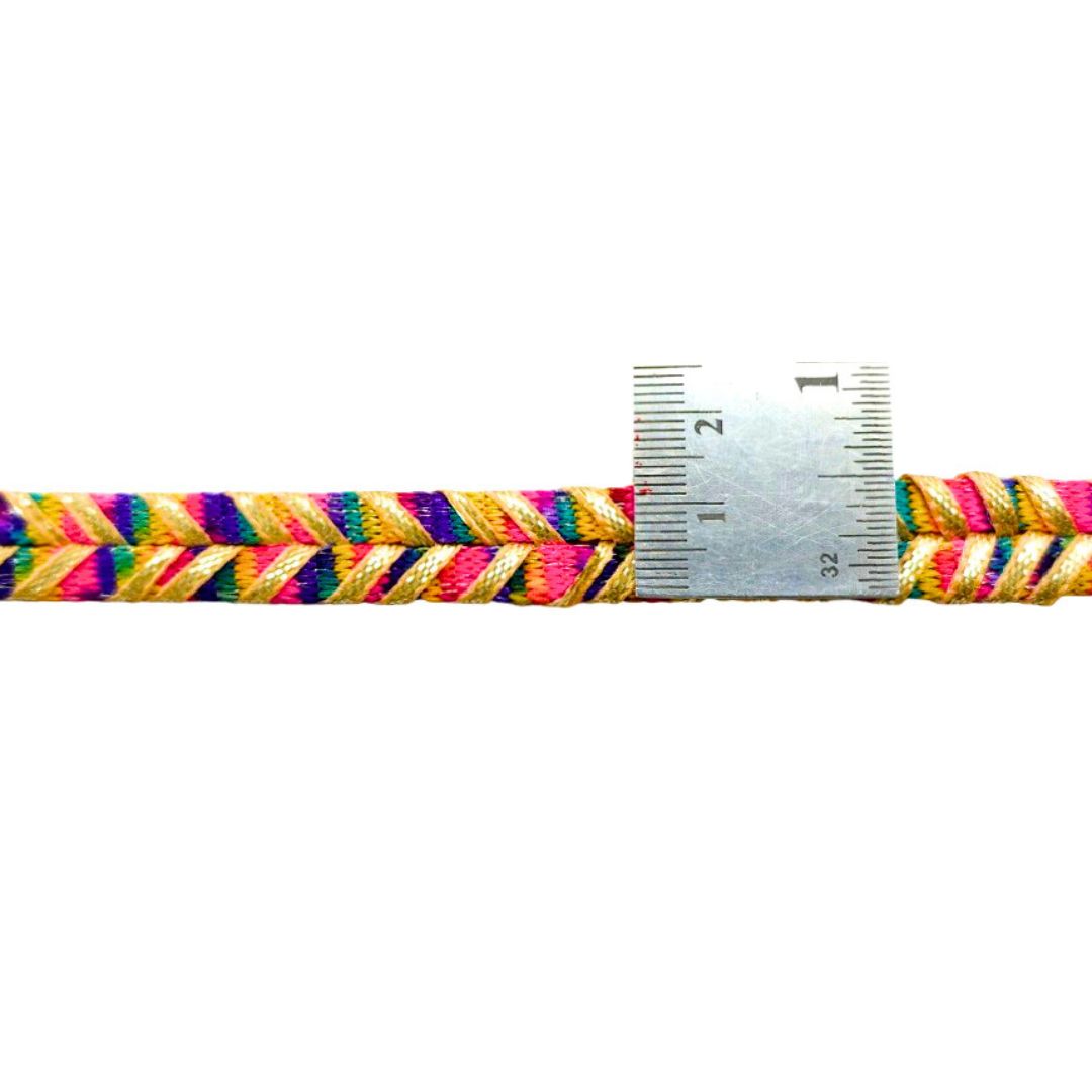 Multicolored braided cord with a ruler for scale on a white background