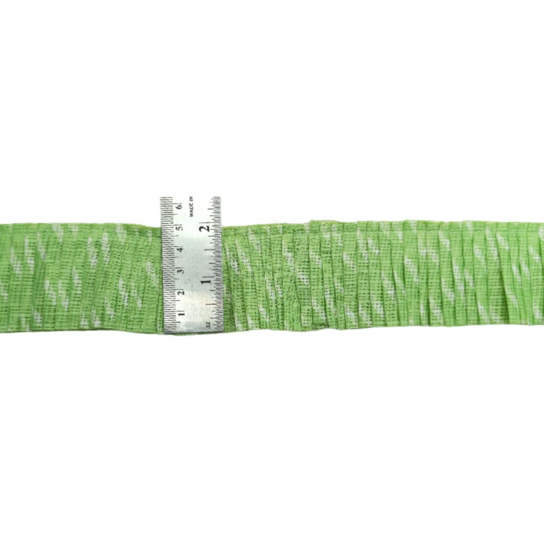 Green ribbon with a ruler for scale on a white background