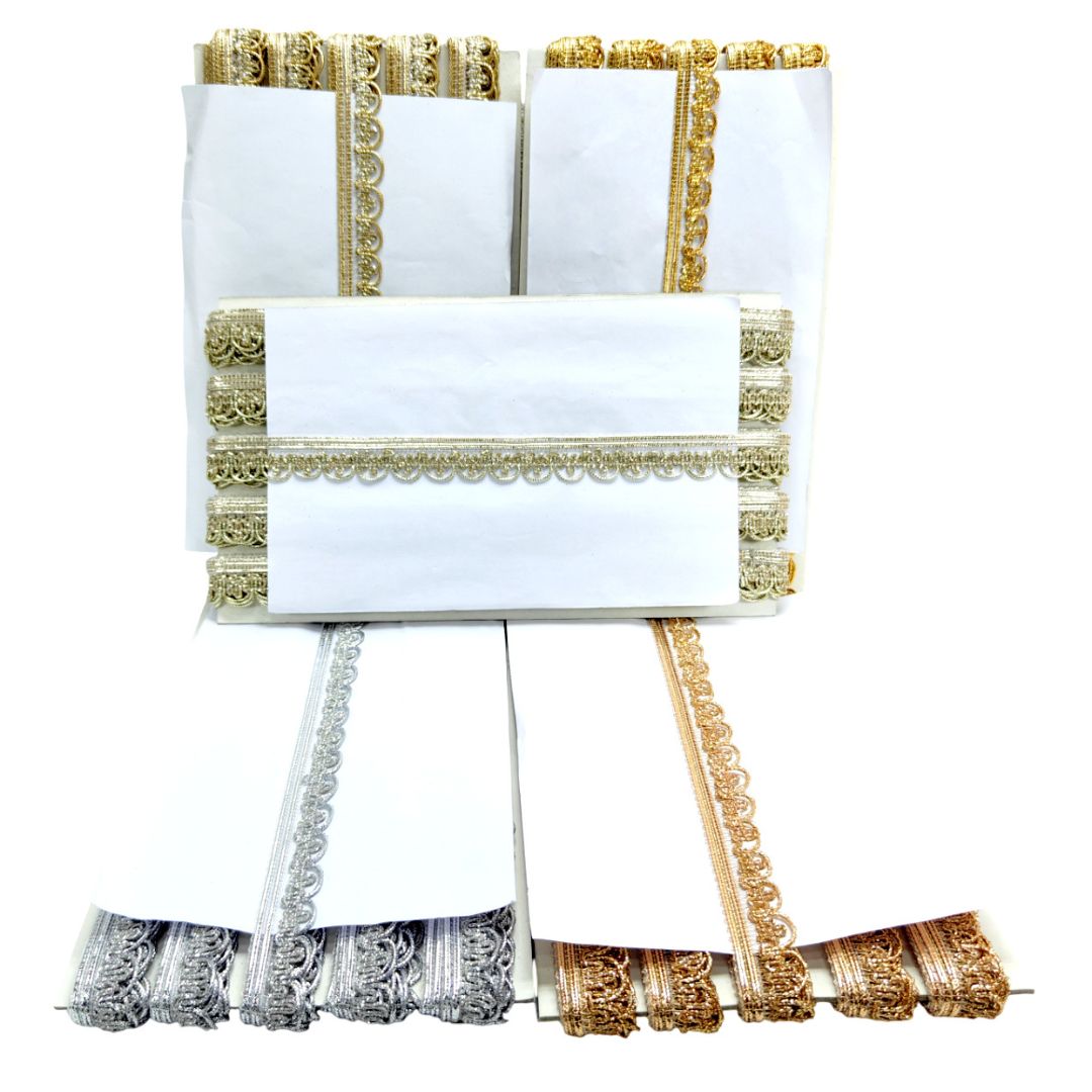 White fabric with gold and silver trim on a white background