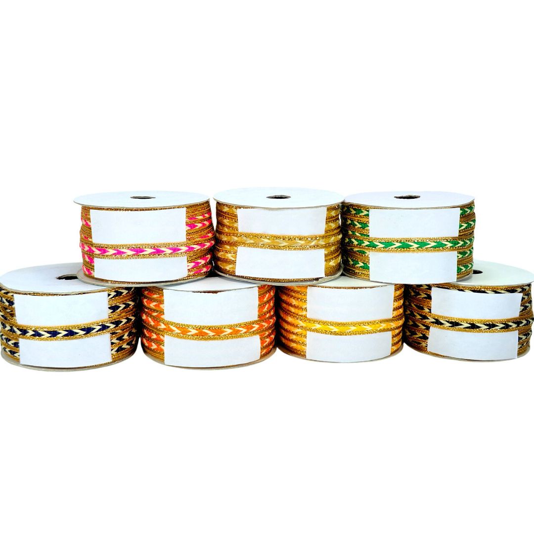 Multiple spools of ribbon with colorful patterns on a white background