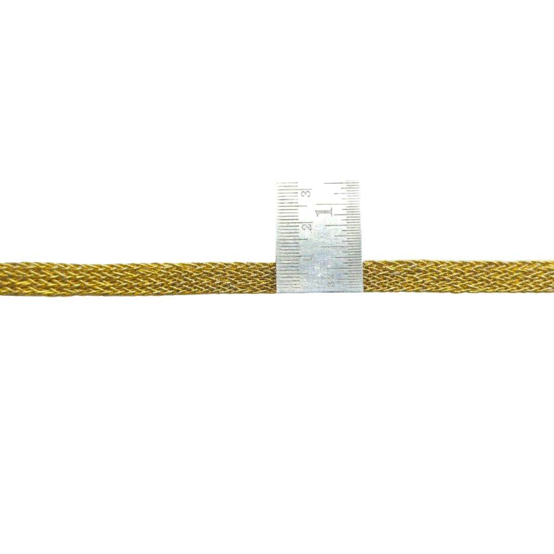Gold-colored braided cable with a ruler for scale on a white background
