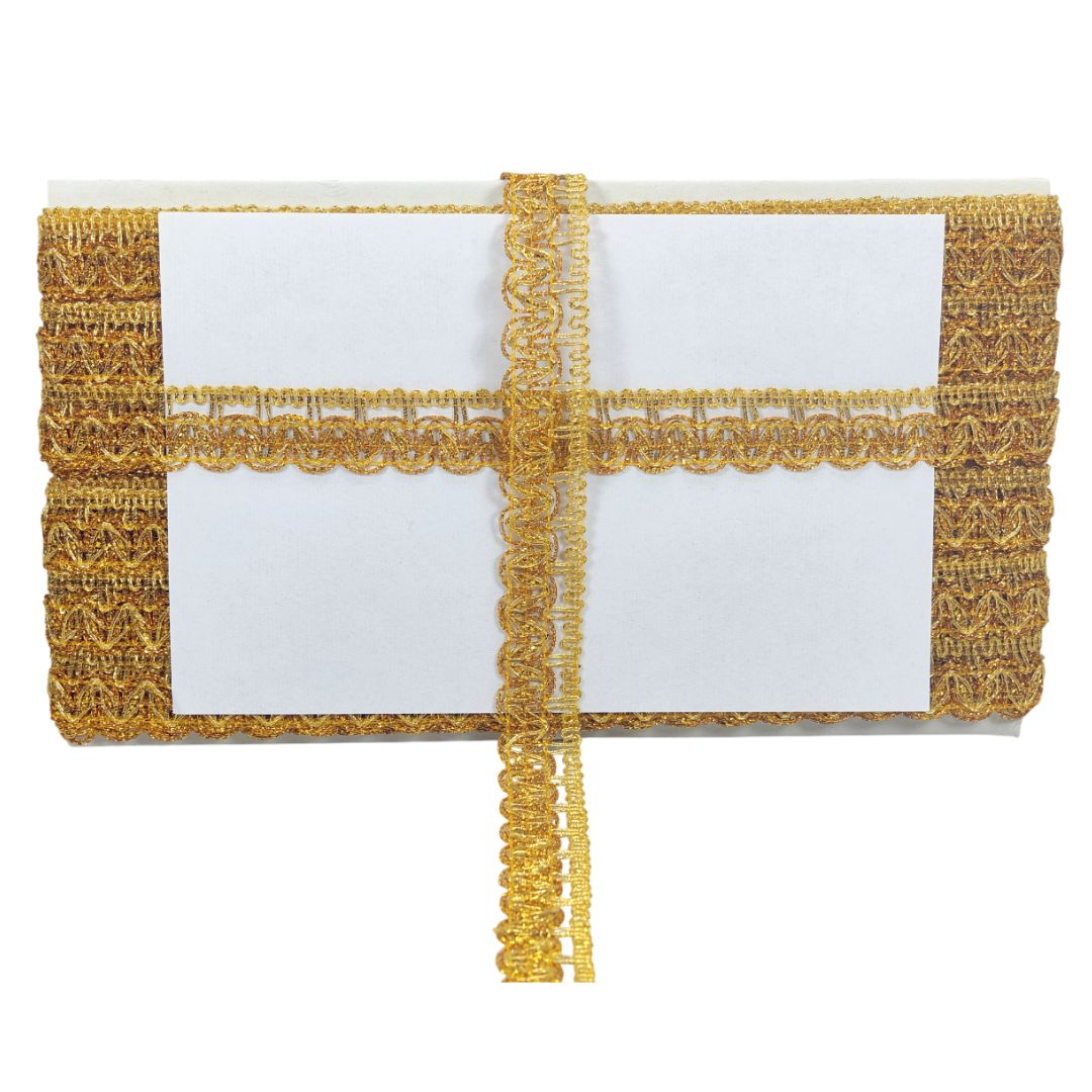 Gold clutch with lace detailing on a white background