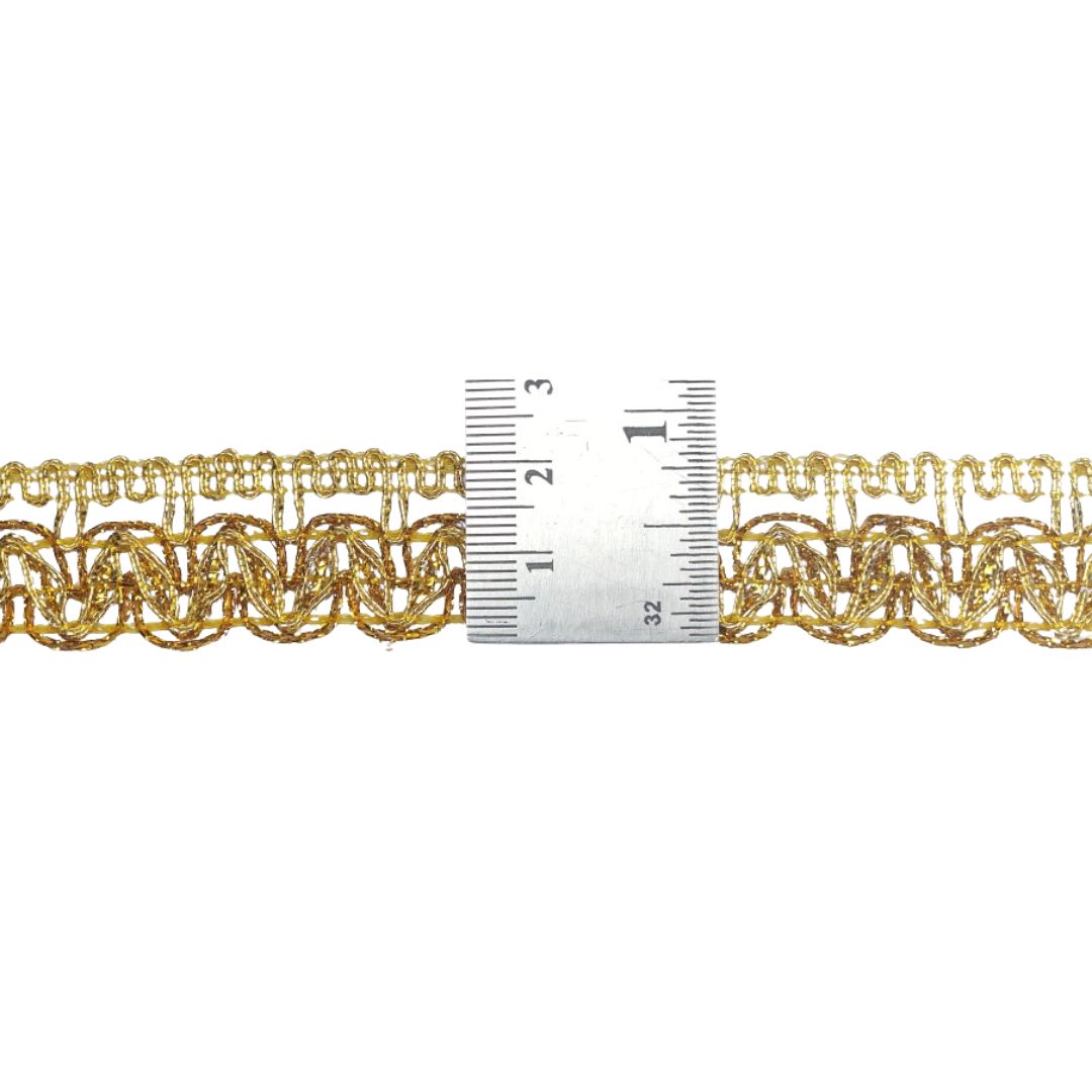 Gold chain with a ruler for scale on a white background