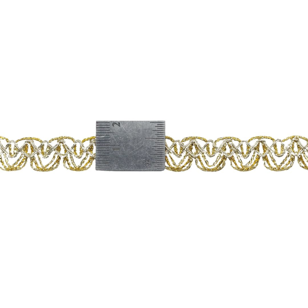 Gold chain with a ruler for scale on a white background