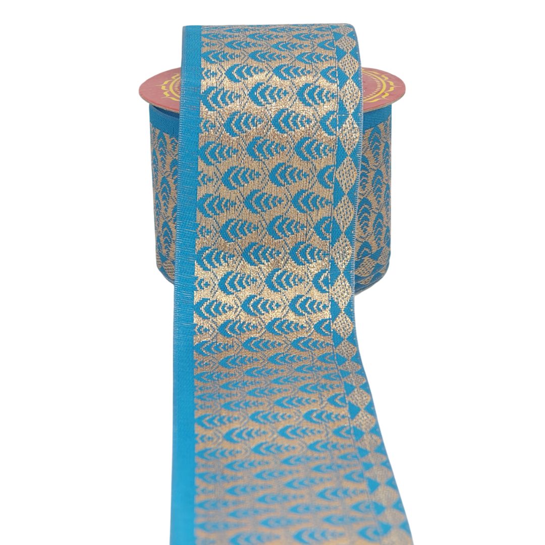 Roll of blue and gold patterned ribbon on a white background