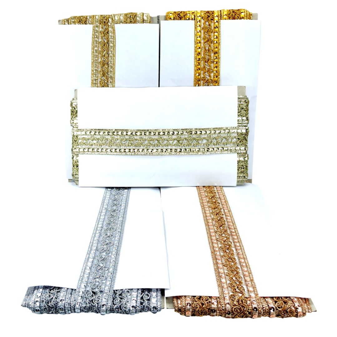 Collection of decorative ribbons in gold, silver, and bronze on a white background