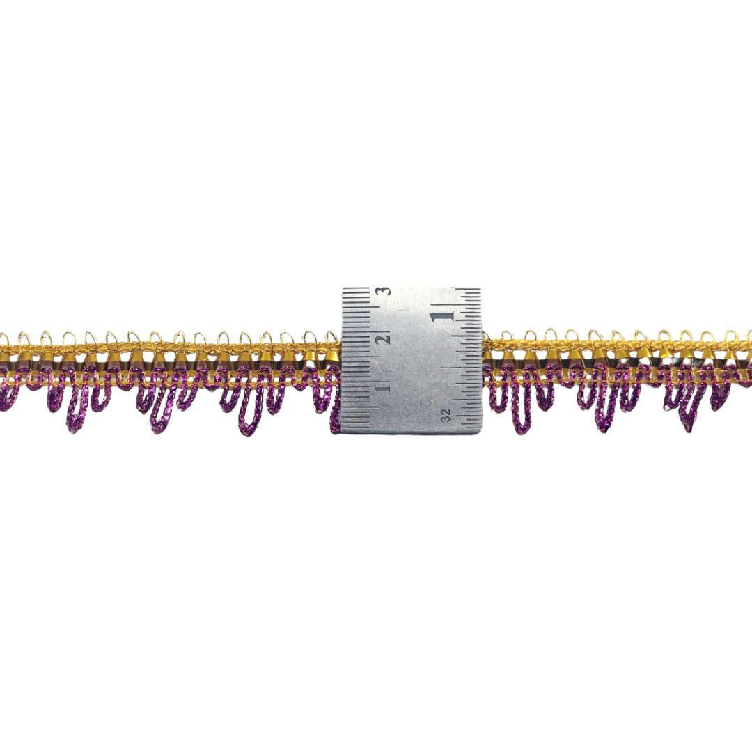 Gold and purple decorative trim with a ruler for scale on a white background