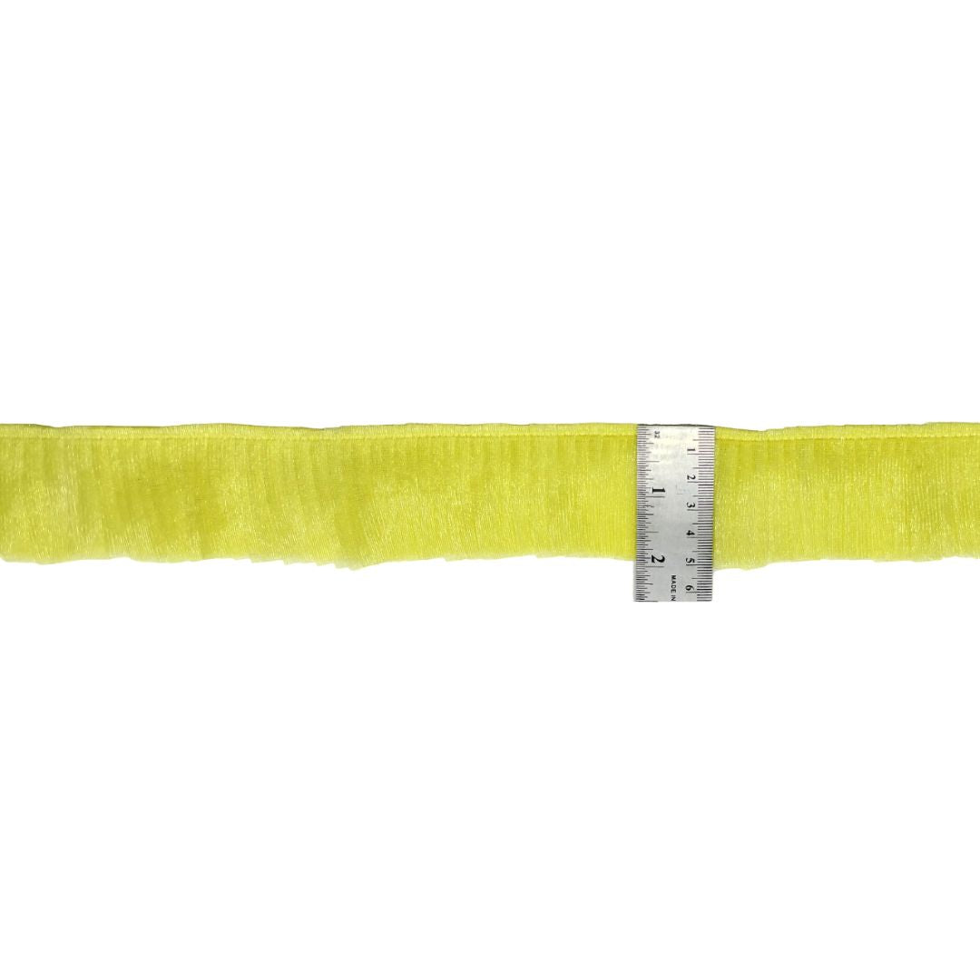 Yellow fabric strip with a ruler for scale on a white background