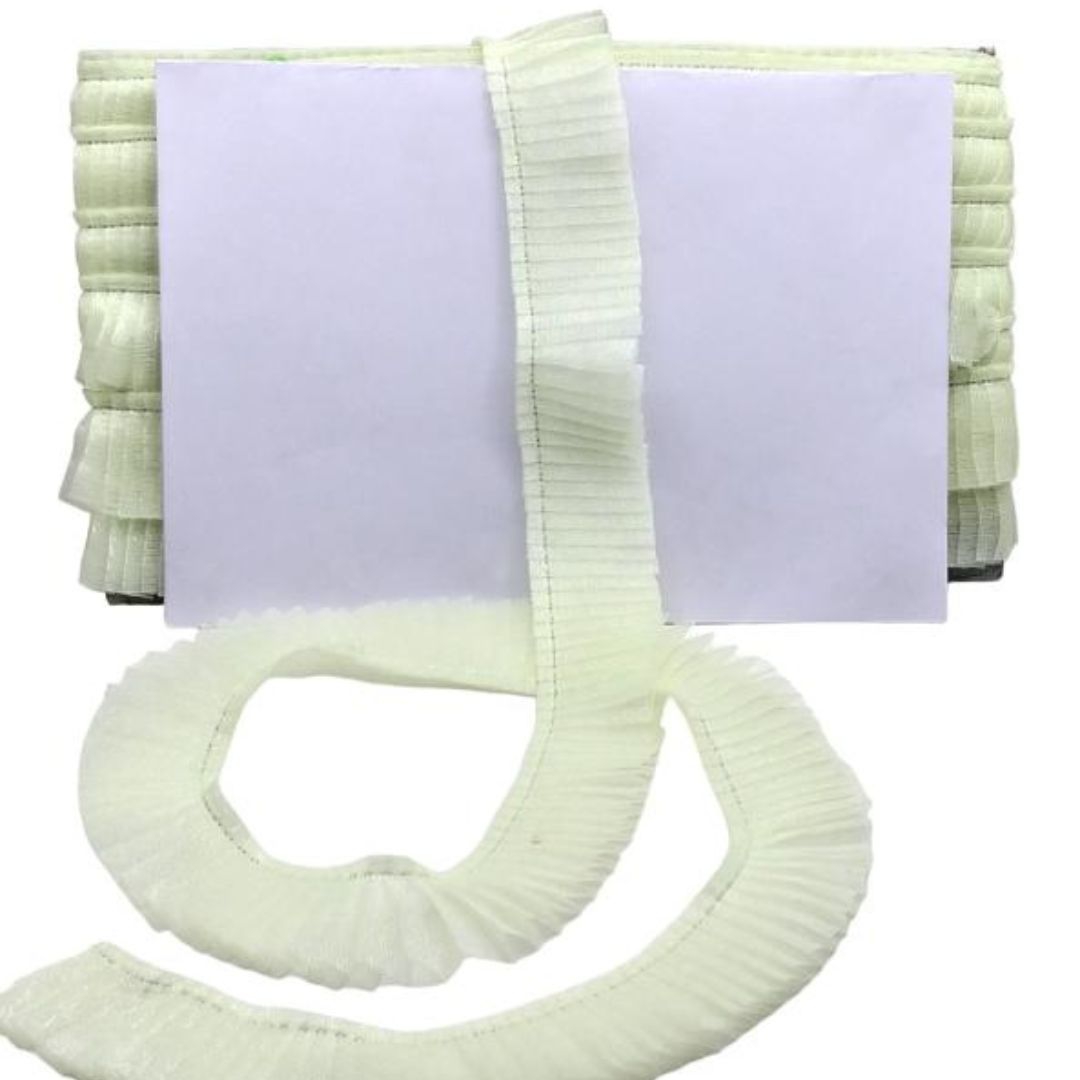 Light green ribbed blanket with a white strap on a white background