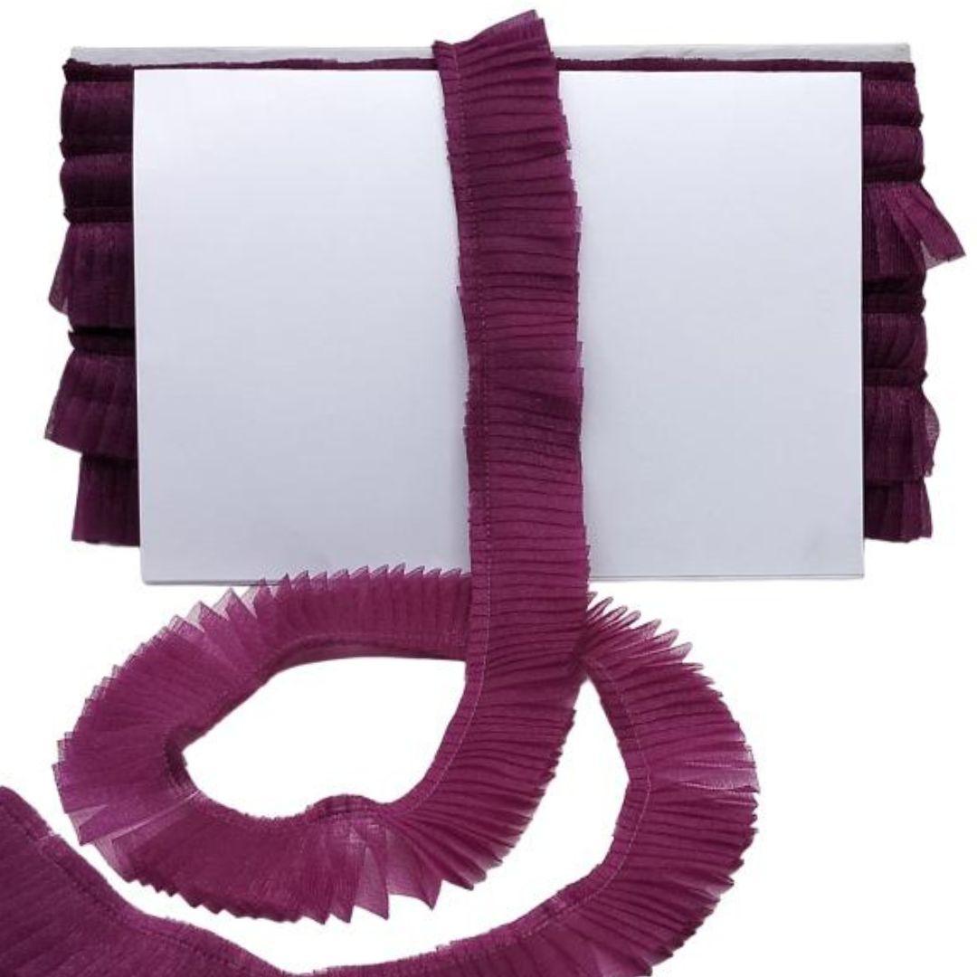 Purple ruffled trim on a white background
